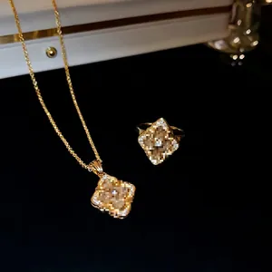 Vintage gold plated flower jewelry set with diamond accents on necklace and ring