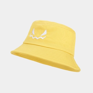 Detail of yellow cotton bucket hat with white embroidered monster face for Halloween