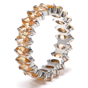 Detailed view of silver eternity ring featuring oval-cut champagne gemstones in a full pavé setting
