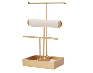 Detailed close-up of 3-tier jewelry organizer stand with soft beige display rolls and slots