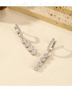 Detailed close-up of S925 sterling silver stamp on shimmering floral tassel earrings