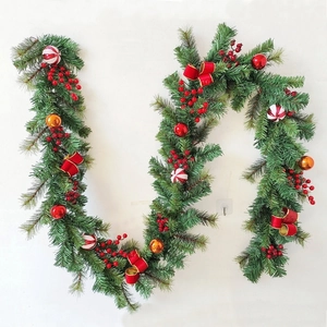 Macro detail of Christmas pine garland with red berries, pinecones and velvet bows