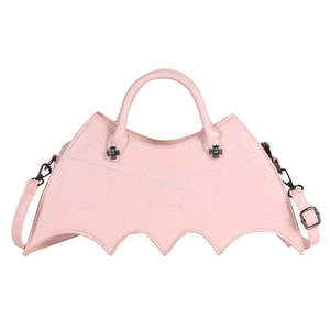 Close-up of pink bat-shaped handbag featuring spider web stitching and metal decor