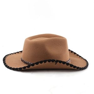 Close-up of brown western felt hat with black whipstitch brim and braided leather band