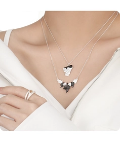 Detail of layered S925 silver leaf necklaces and matching ring with yellow gemstone