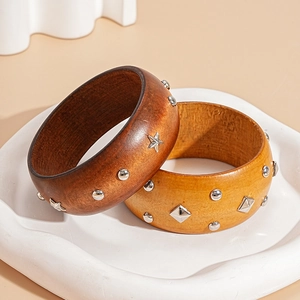 Retro wooden round bangles with star rivets and geometric metal studs on a white plate