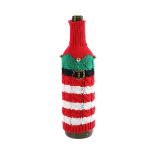 Knitted Christmas wine bottle cover in red and green with a belt and golden bell
