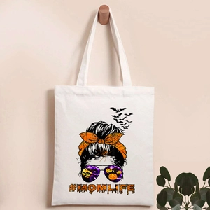 Detail of white canvas tote featuring Halloween skeleton and pumpkin #MOMLIFE print