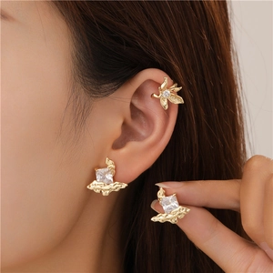 Gold earrings set with square zircon featuring organic lava texture for women