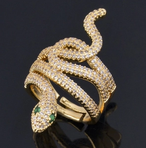 Golden snake ring with white zircons and green eyes in an adjustable open wrap design
