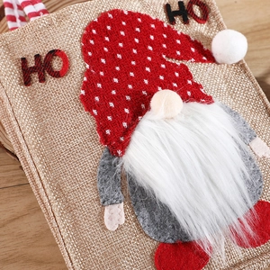 Christmas gnome burlap gift bag with red polka dot hat and HO HO lettering on wood