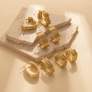 Golden wheat-patterned textured earrings set with geometric weave and oval twist design