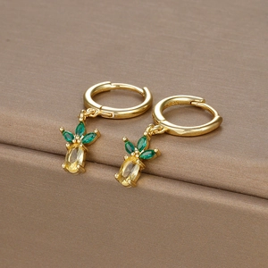 Macro detail of gold pineapple earrings showing S925 hallmark and colorful cubic zirconia