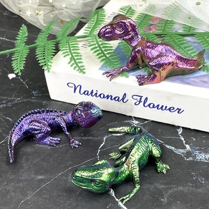 Detailed view of 3D dinosaur resin molds with iridescent metallic finish and scales