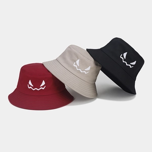 Detail of Halloween bucket hats with ghost face embroidery in burgundy, beige and black