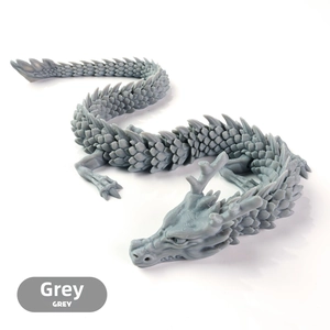 Top-down view of grey 3D printed articulated dragon figure with detailed scales and joints
