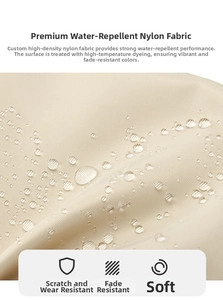 Close-up of beige nylon fabric with water-resistant droplets showing durable texture