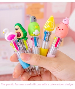 Macro detail of multi-color ballpoint pens with soft silicone cartoon character toppers