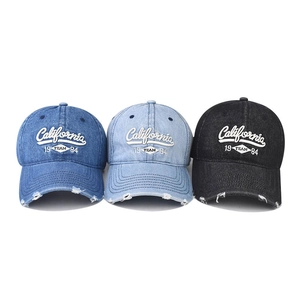 Distressed California denim baseball caps in blue and black with 1984 embroidery
