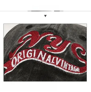 Detail of NYC vintage embroidery on dark gray washed cotton baseball cap with retro texture