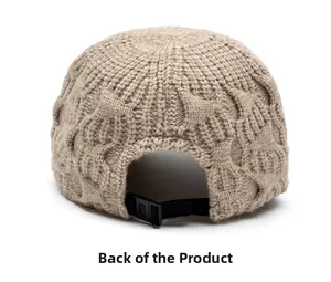 Detail of adjustable black strap and buckle on beige knitted winter baseball cap