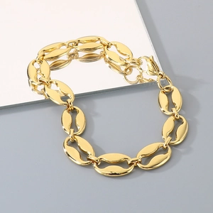 Macro shot of gold coffee bean link bracelet with polished titanium steel finish