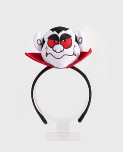 Front view of plush vampire themed headband accessory on a transparent display stand