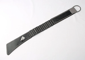 Detail of black punk style elastic belt featuring silver studs and large gunmetal D-ring