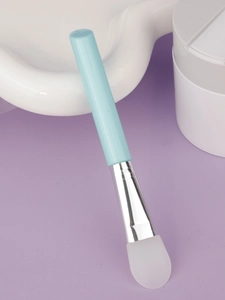 Detail of soft silicone face mask brush with light blue handle and metal ferrule