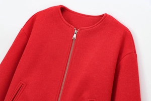 Close-up of red wool-feel bomber jacket featuring premium metal zipper and round collar