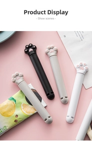Close-up of cute cat paw bag clips in black, white and grey on a warm pink background