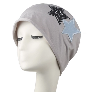 Gray knitted star beanie with ear protection and embroidery on a white mannequin head