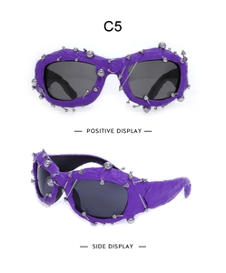 Detail view of purple punk sunglasses with silver metal studs and rivets on white background