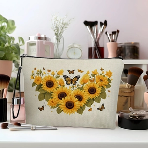 Sunflower canvas makeup bag with floral print and black zipper on a vanity desk