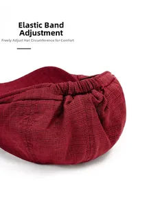 Close-up of the elastic adjustment strap on the wine red beret hat with textured fabric