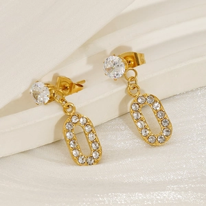 Macro detail of 18K gold-plated titanium steel earrings with sparkling zircon stones