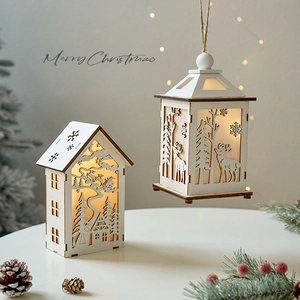 Lighted wooden Christmas cabin and lantern ornaments with reindeer and snowflake cutout