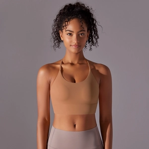 Close-up of brown criss-cross back sports bra with thin straps and seamless nylon fabric