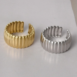 Detail view of 18k gold and silver geometric rings with textured crinkle finish