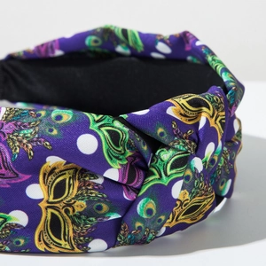 Close-up of knot detail on Mardi Gras headband with purple fabric and mask patterns