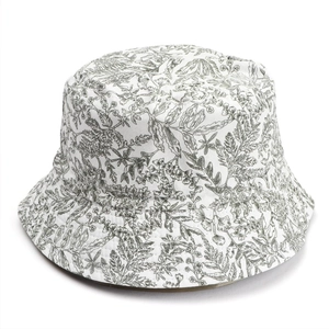 Detailed close-up of breathable cotton fabric with dark grey floral and leaf patterns