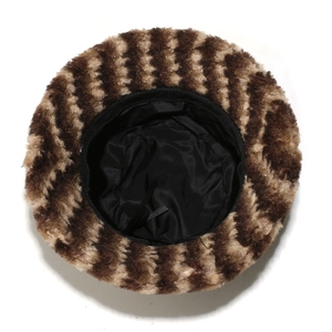 Detailed top view of faux fur bucket hat featuring striped plush texture and inner lining