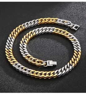 Detail of two-tone gold and silver Cuban chain necklace with secure metal square clasp
