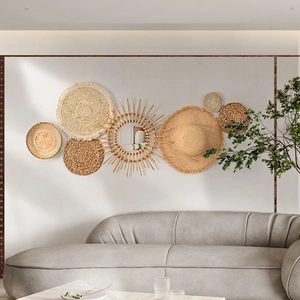 Detailed view of bohemian straw wall decor set with natural woven textures above a grey sofa