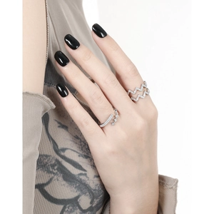 Crossed wavy silver S925 ring with white cubic zirconia crystals on female hand