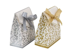 Detail of European style gold and silver candy boxes with vintage patterns and silk bows