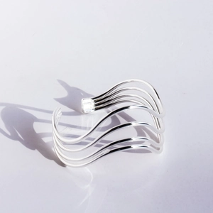 Modern minimalist silver wave open bangle with a layered cutout geometric design