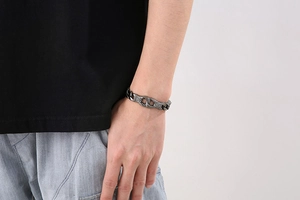 Close-up of retro gun black stainless steel chain bracelet on male model wrist