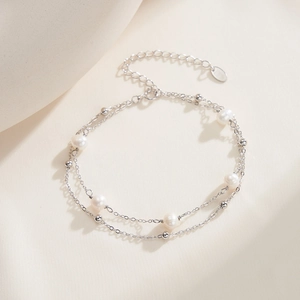 Detail of double-layer sterling silver bracelet with freshwater pearls and silver beads