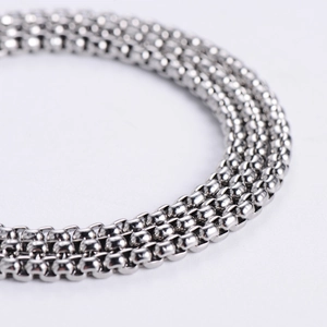 Macro shot of high-polished stainless steel square box chain links with silver finish